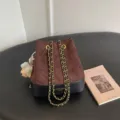 Brown quilted suede bucket bag with black leather base, gold chain strap and cute bear charm. - With Pendant / Coffee