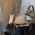 Beige straw woven crossbody shoulder bag with chic brown leather trim and stylish strap. - Off White