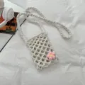 Cute crochet phone bag with pink flower accent, casual woven crossbody bag for beach use. - With Flower Decor / White