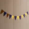 Close up view of blue and gold metallic triangular pennant garland for party decoration details. - Royal Blue and Mirror Gold Pennants