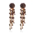 Detail view of retro bronze beaded floral long tassel earrings with intricate flower clusters. - Brown