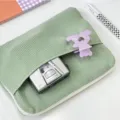 Detailed view of green corduroy laptop sleeve pouch, soft texture with front pocket and zipper. - 11" / Light Green