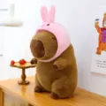 Cute capybara plush toy with a pink rabbit hat, soft stuffed animal for gifting. - 23cm / Rabbit