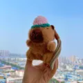 Cute brown capybara plush keychain with knitted hat variant, soft bag pendant accessory. - Straw Hat Pink Capybara