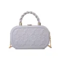 Chic grey box handbag featuring twisted top handle, gold chain strap and embossed clover motif. - Gray