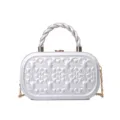 Silver clutch bag with twisted handle and chain strap, featuring elegant embossed clover pattern. - Silver