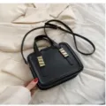 Black minimalist crossbody shoulder bag for women, stylish handbag with metal decor and strap. - Black