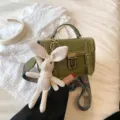 Vintage green structured mini handbag with lock closure, patterned strap and cute rabbit charm. - Green (With Charm)