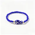 Bracelet en perles bleues avec charm poisson et œil protecteur style boho - Poisson à Pois Bleus