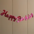Close up of shiny pink hot stamping happy birthday letter banner party decoration detail view - New Script Birthday Rose Red Banner