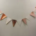 Detail shot of rose gold metallic and chevron triangle bunting banner for festive party decor. - Rose Gold Hot Stamped Wavy Pennant