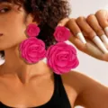 Close-up of a model wearing large bright pink fabric rose dangle earrings - Rose Red Two Flowers