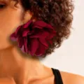 Close-up of a large burgundy fabric flower earring on a model for a romantic look - Wine Red One Flower