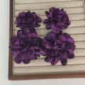 Elegant deep purple fabric flower earrings displayed neatly on a beige jewelry tray - Purple Two Flowers