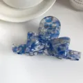 Blue acetate hair claw clip with 3D bow design, elegant marble pattern hairpin detail view. - Floral Blue