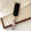 Acetate hairbrush detail featuring floral pattern, boar bristles and cute cat ear top design. - Boar Bristle Style - Floral