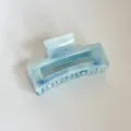 Detail view of blue marble plastic hair claw clip, stylish and glossy shark clip for daily use. - 1# Blue