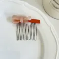 Close-up detail of the Korean style bow acetate hair comb with metal teeth, elegant design. - #5 Red Base Clip