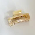Detailed view of Korean plastic tortoiseshell hair claw clip featuring glossy finish for styling. - 2# Yellow