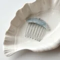Detail shot of blue acetate crown hair comb with sparkling rhinestones and metal teeth. - Blue