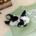 Cute black and white plush cow keychain with floral accents, soft animal toy bag charm - Cow