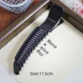 Detail view of black plastic hair root volumizing duckbill clip, measuring 11.5 cm. - Hollow Volumizing Clip / Black