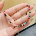 Detail view of colorful bohemian stone necklace held in hand showing bead textures - Multicolor Beaded Style / Colorful