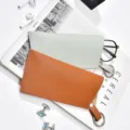 Detailed shot of thickened leather glasses pouch, portable anti-scratch sunglasses storage bag. - Spring Ring Glasses Pouch Brown