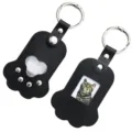 Black leather paw photo keychain detail, cute pet memory holder with metal ring and secure snap. - Black