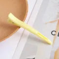 Yellow plastic hair salon styling clip, professional duckbill hair clamp detail view. - [Yellow] Professional Hair Styling