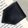 Black leather magnetic bookmark with elegant stitching, perfect reading accessory for book lovers. - Black