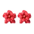 Closeup detail of elegant glossy red flower earrings featuring vibrant petals and gold pistil. - Burgundy