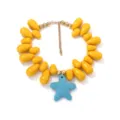Close-up detail of the beach style yellow teardrop bead necklace with blue starfish pendant. - Style 6