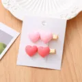 Gros plan de pinces à cheveux cœur rose et rouge, jolie barrette bec de canard métal. - Pinces à cheveux cœur (paire)