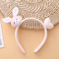Close-up detail of cute pink plush bunny headband with sweet heart accessory for autumn. - Rabbit and Heart Headband