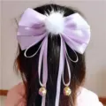 Kids hair bow detail showing light purple satin ribbon, white pompom and hanging bells. - Purple Bow with White Pom-pom
