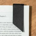 Black leather corner page bookmark detail view, elegant reading accessory for books. - Black