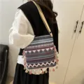 Ethnic style retro shoulder bag detail showing geometric pattern and tassels hanging nicely. - Purple