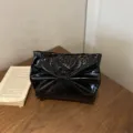 Black patent leather clutch bag with a large bow, stylish and trendy for evening parties. - Black
