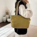 Detailed view of the casual corduroy tote bag showcasing its side pocket and texture. - Yellow