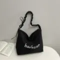 Black casual slouchy shoulder bag with white letter print, lightweight daily commuter tote bag. - Black
