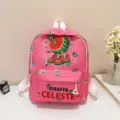 Detailed view of the cute pink kids school backpack featuring unique cartoon giraffe design. - Rose Red