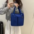Detailed view of the multi-pocket blue canvas tote bag, showcasing practical storage design. - Sapphire Blue