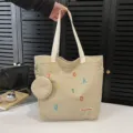 Stylish canvas tote bag for women, large capacity shoulder handbag with pouch and letters. - Off White