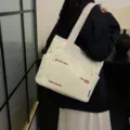 Canvas tote bag for women, large capacity shoulder bag with literary design and pockets. - White