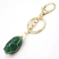 Detail view of gold-toned metal wire wrapped green stone keychain pendant accessory. - Lobster Clasp / Green Aventurine