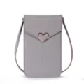 Detail shot of the grey mini crossbody phone bag highlighting the chic rose gold heart clasp. - Light Gray