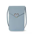 Detail view of the light blue mini crossbody phone bag with chic metal heart clasp detail. - Blue
