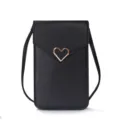 Close-up detail of the black mini crossbody phone bag with rose gold heart emblem. - Black