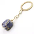 Closeup detail of wire-wrapped natural stone keyring pendant with gold metal ring. - 3-Section Chain / Blue Spot Stone